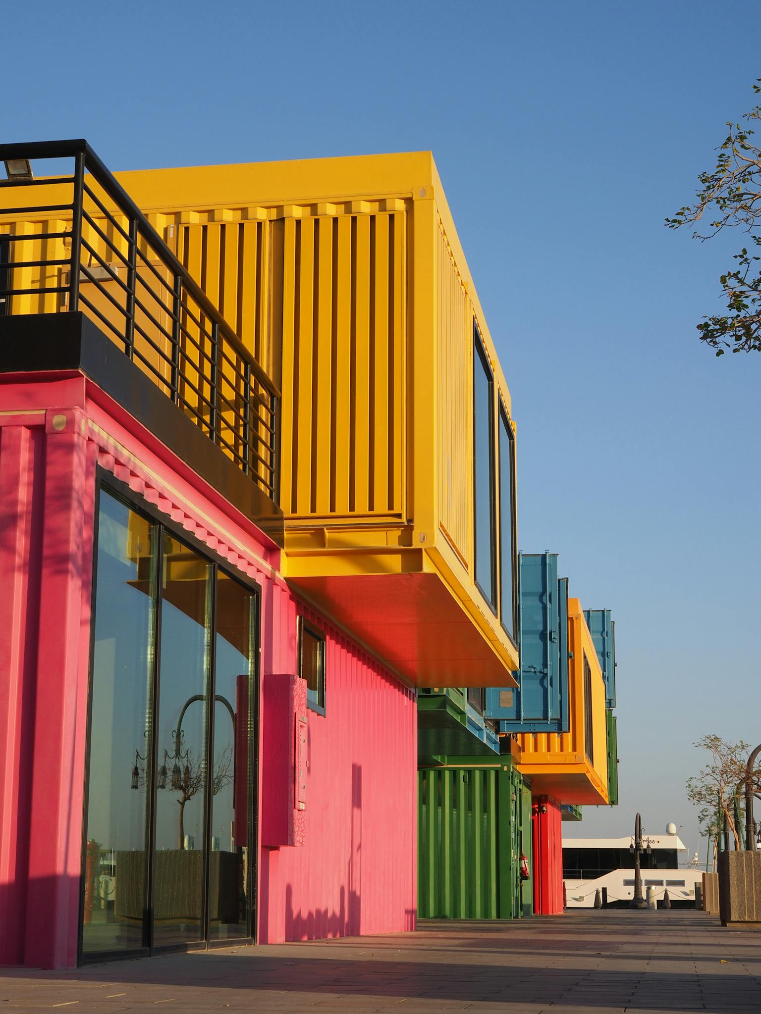 Colorful shipping container-themed building captured on a sunny day in Doha, Qatar.